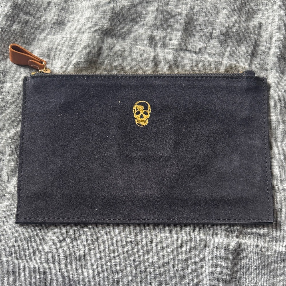 Elegant Black Suede Wristlet with Gold Skull Design